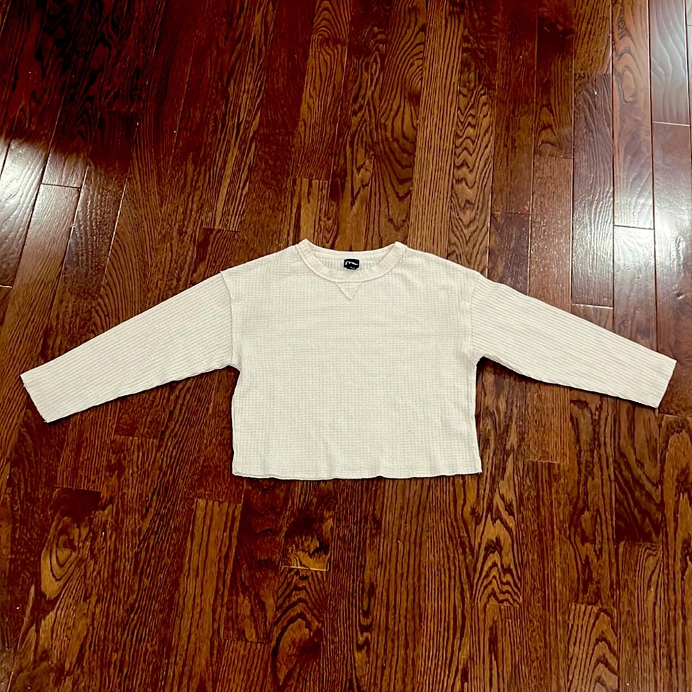White colored, thin, grid-textured long sleeve shirt.